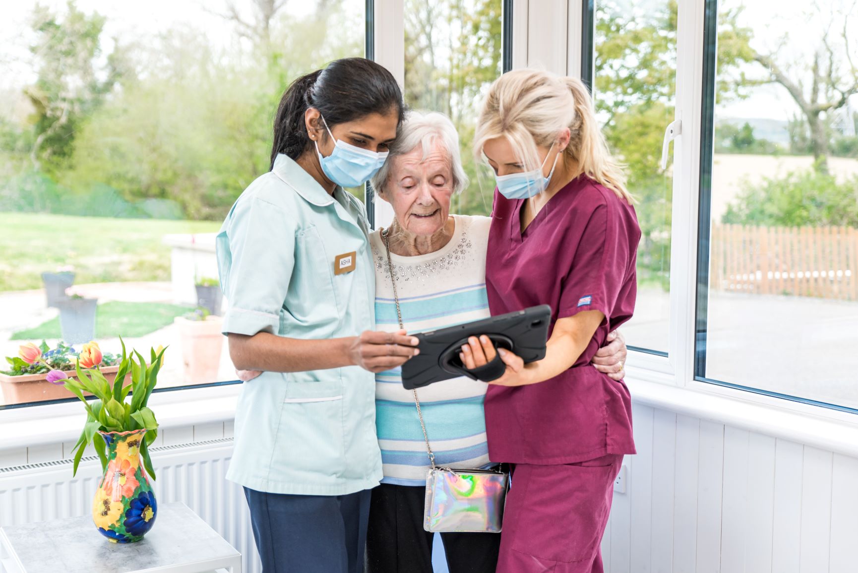 Two nurses reviewing a care plan with a resident.